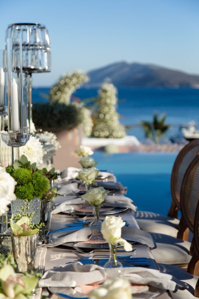 Elegant outdoor dining table arranged beside the sea at a Mediterranean villa