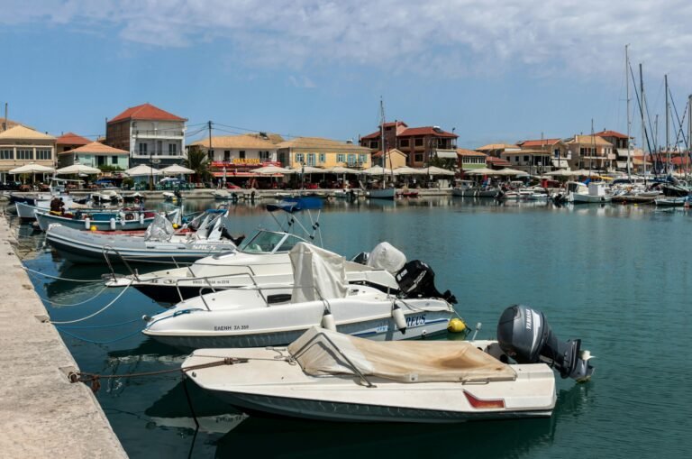 Small boats moored beside colourful waterfront buildings in Lefkada
