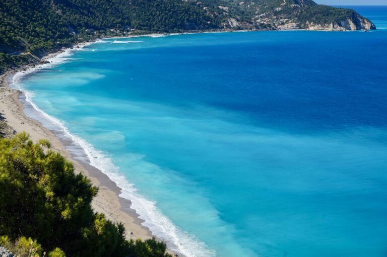 Turquoise water and a long beach along the mountainous west coast of Lefkada