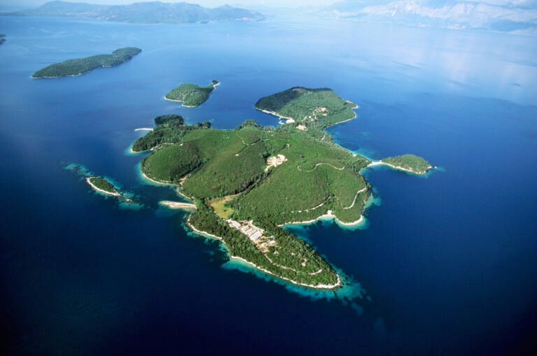Aerial view of the forested Skorpios Island surrounded by the Ionian Sea