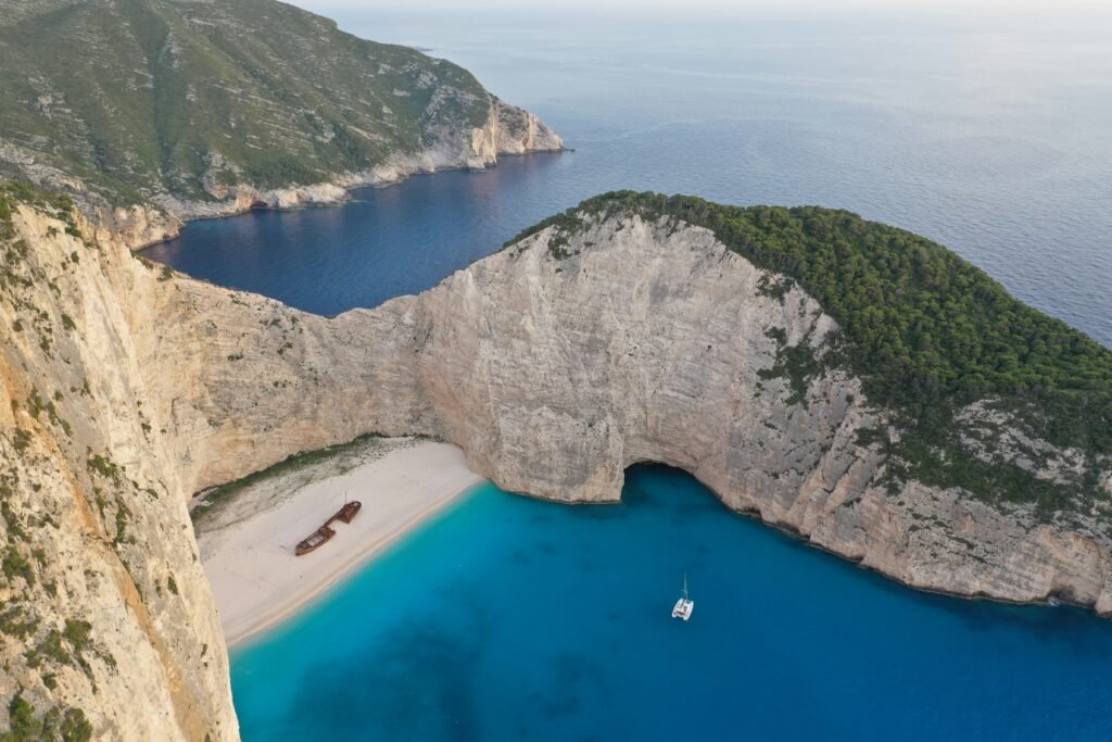Aerial view of Shipwreck Beach surrounded by limestone cliffs in Zakynthos
