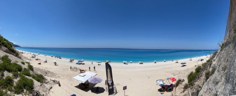 Wide view across Egremni Beach and turquoise water beneath the limestone cliffs