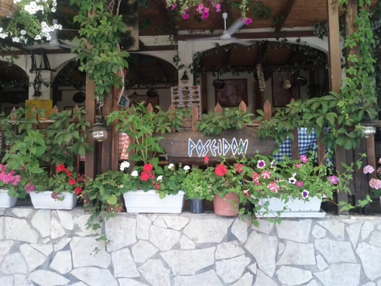 Flowerpots and outdoor taverna seating in Agios Nikitas